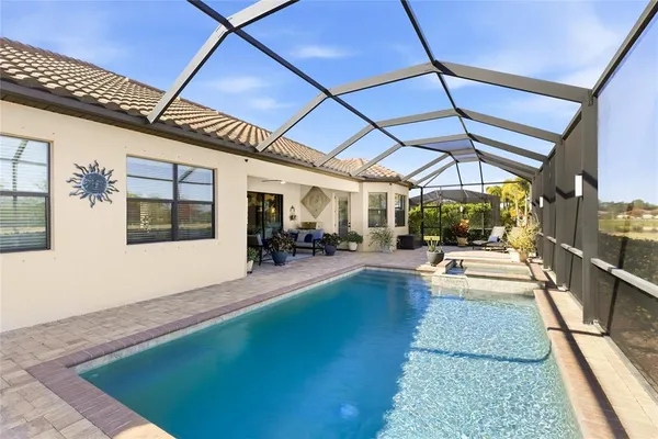 a view of a patio with table and chairs under an umbrella