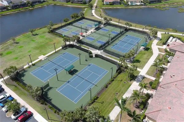 an aerial view of residential houses with outdoor space and swimming pool