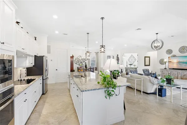 a large room with lots of white furniture