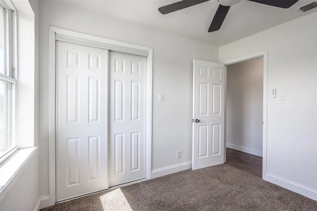an empty room with closet area
