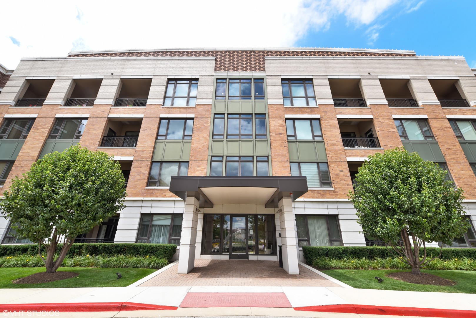 1000 Village Center Drive, Unit 312 Burr Ridge, IL 60527 - Photo 1 of 25 a front view of a building with a garden