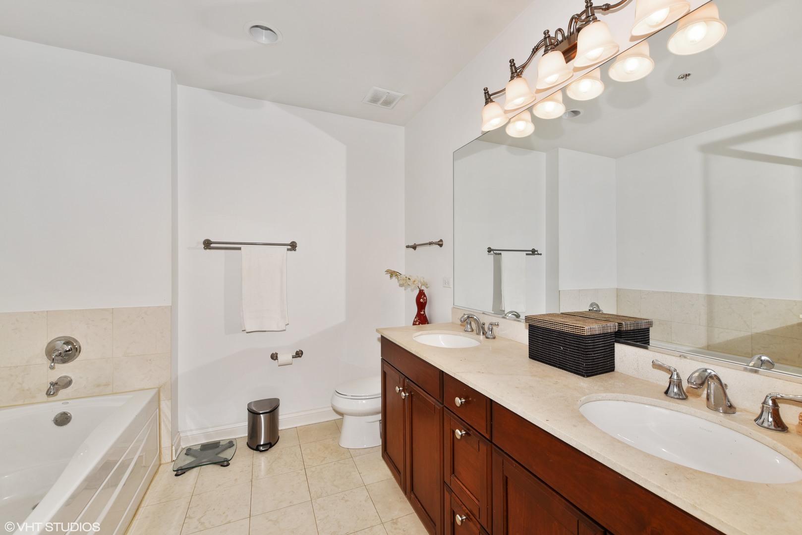 1000 Village Center Drive, Unit 312 Burr Ridge, IL 60527 - Photo 14 of 25 a spacious bathroom with a double vanity sink mirror and a bathtub