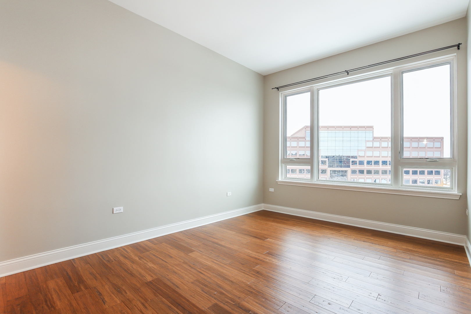 1000 Village Center Drive, Unit 312 Burr Ridge, IL 60527 - Photo 16 of 25 a view of empty room with wooden floor and fan