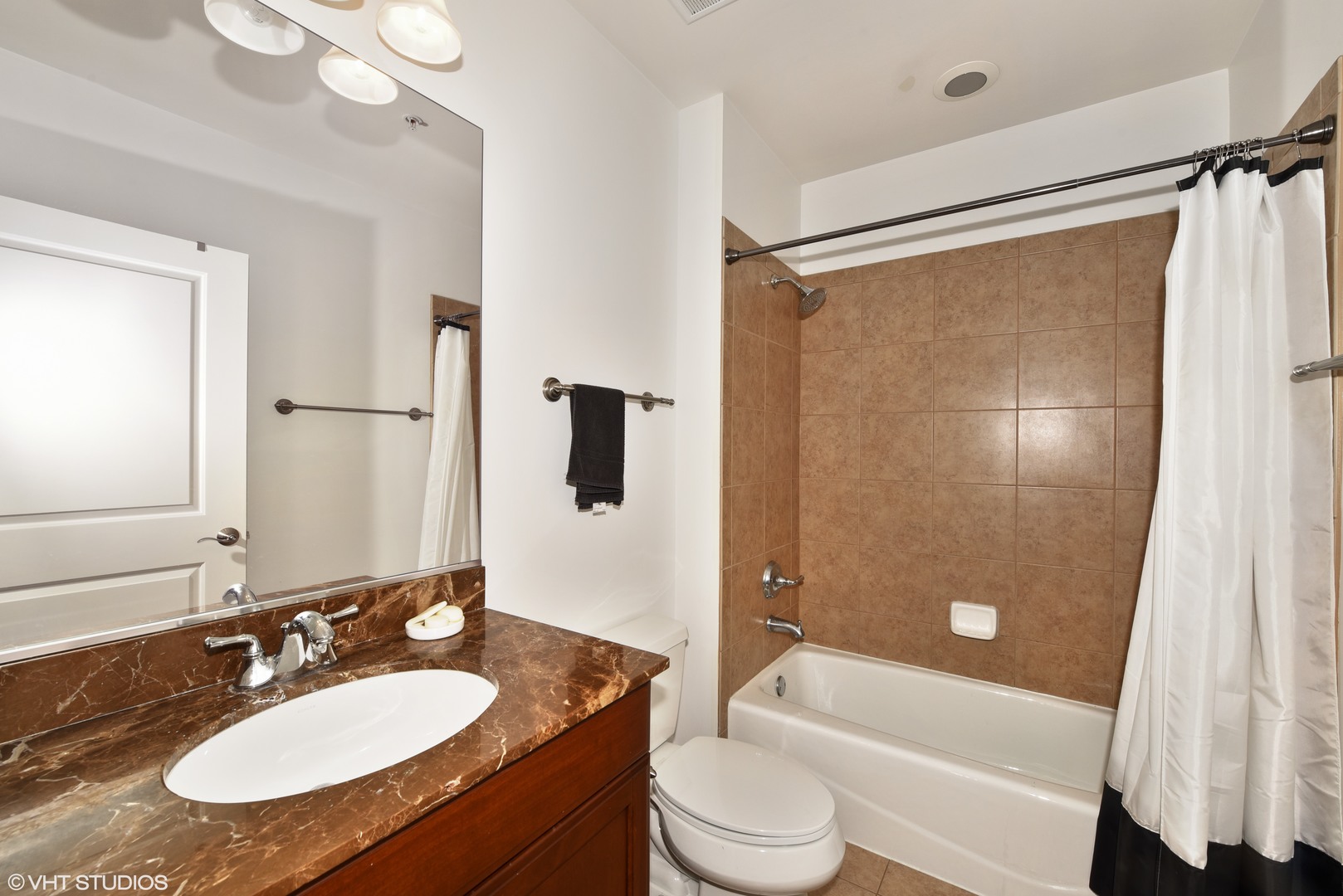 1000 Village Center Drive, Unit 312 Burr Ridge, IL 60527 - Photo 18 of 25 a bathroom with a granite countertop sink toilet and shower