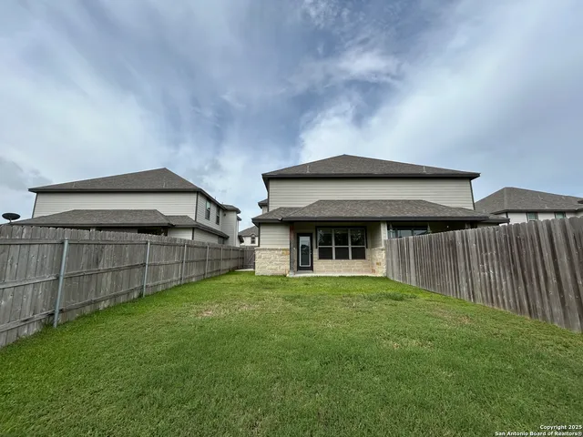 a view of a house with a yard and sitting area
