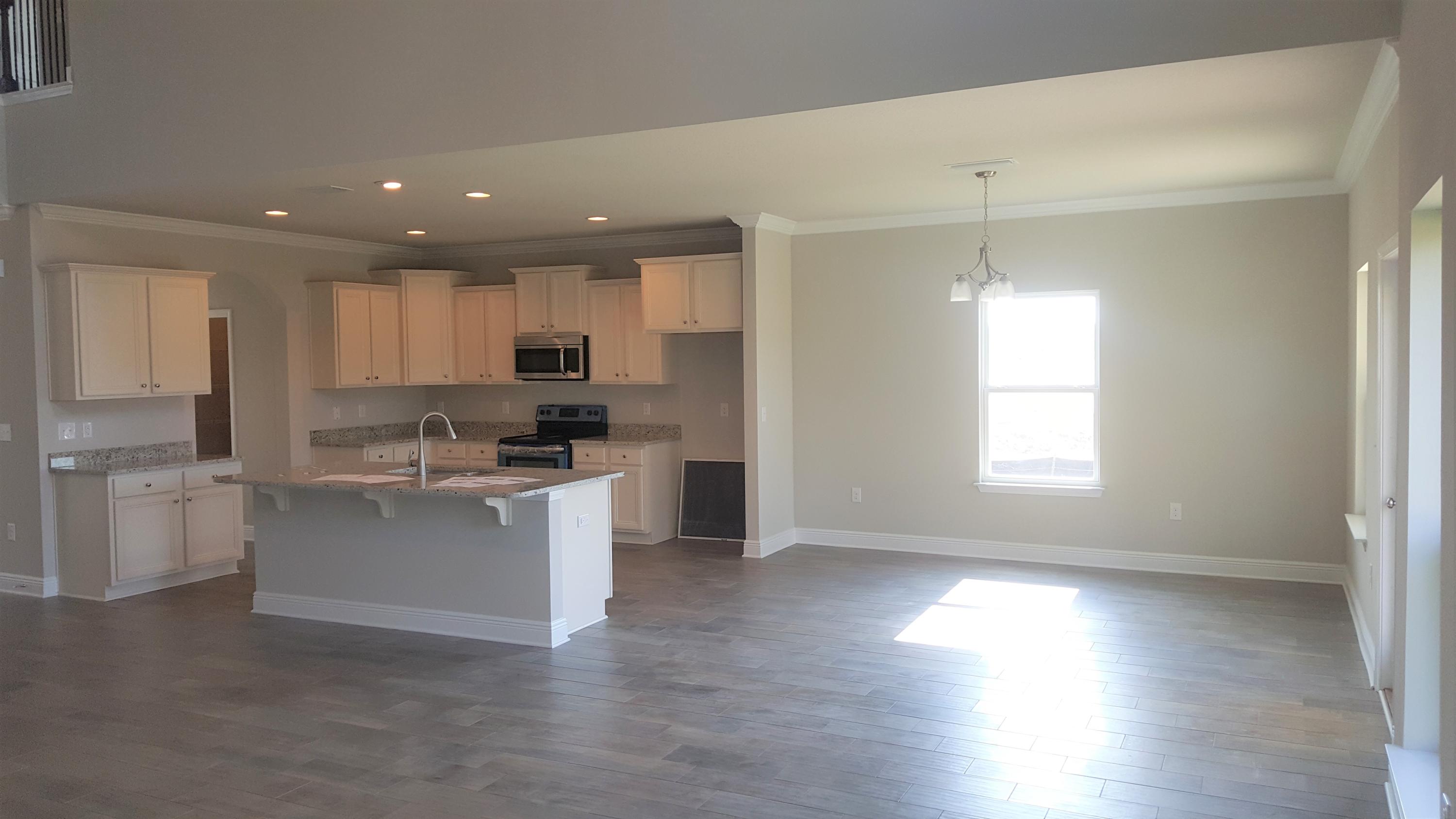 200 Conner Circle Santa Rosa Beach, FL 32459 - Photo 5 of 31 a kitchen with a white cabinets and wooden floor