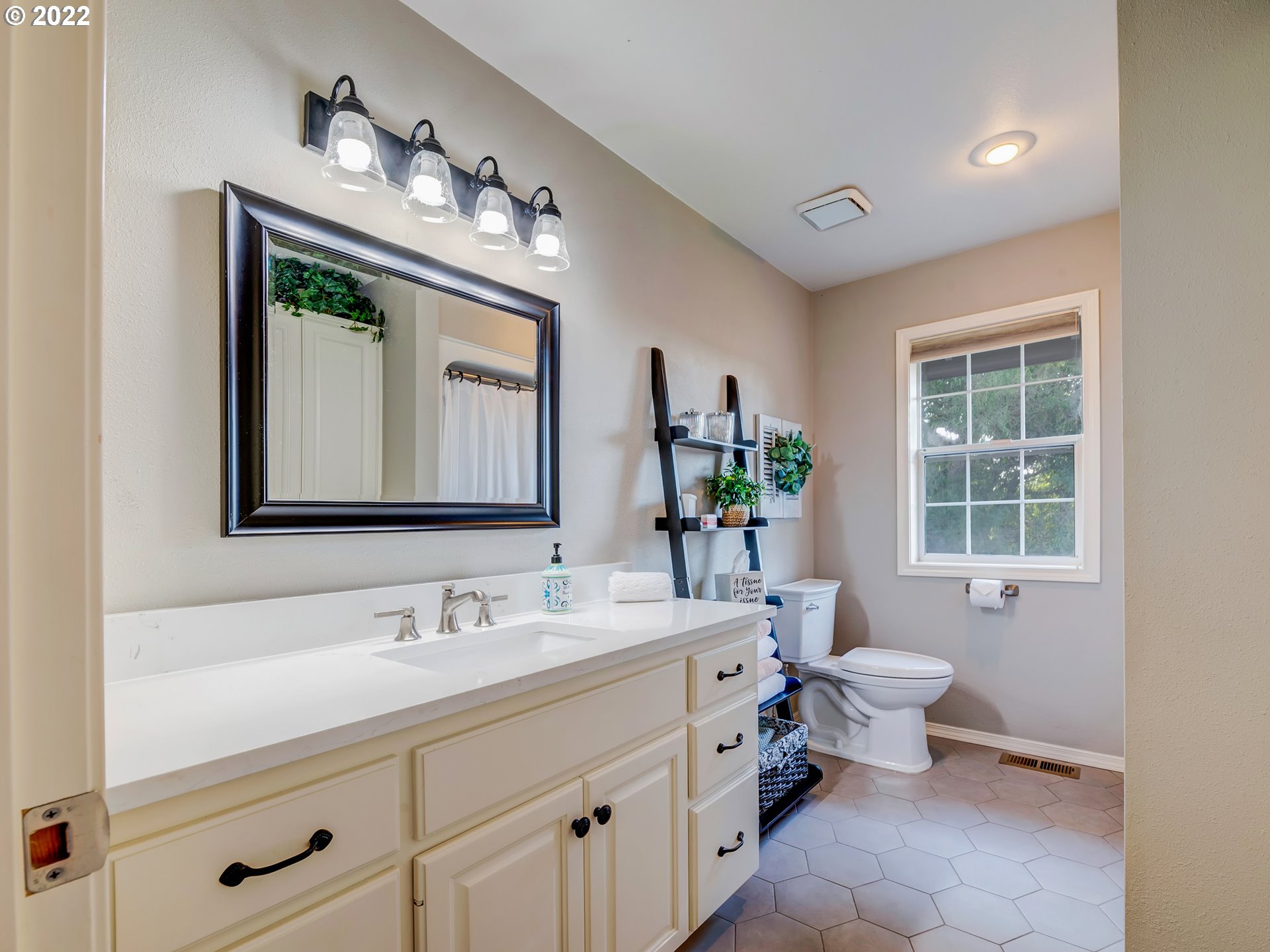 28244 Edgewater Drive Eugene, OR 97402 - Photo 19 of 30 a bathroom with a toilet sink and mirror