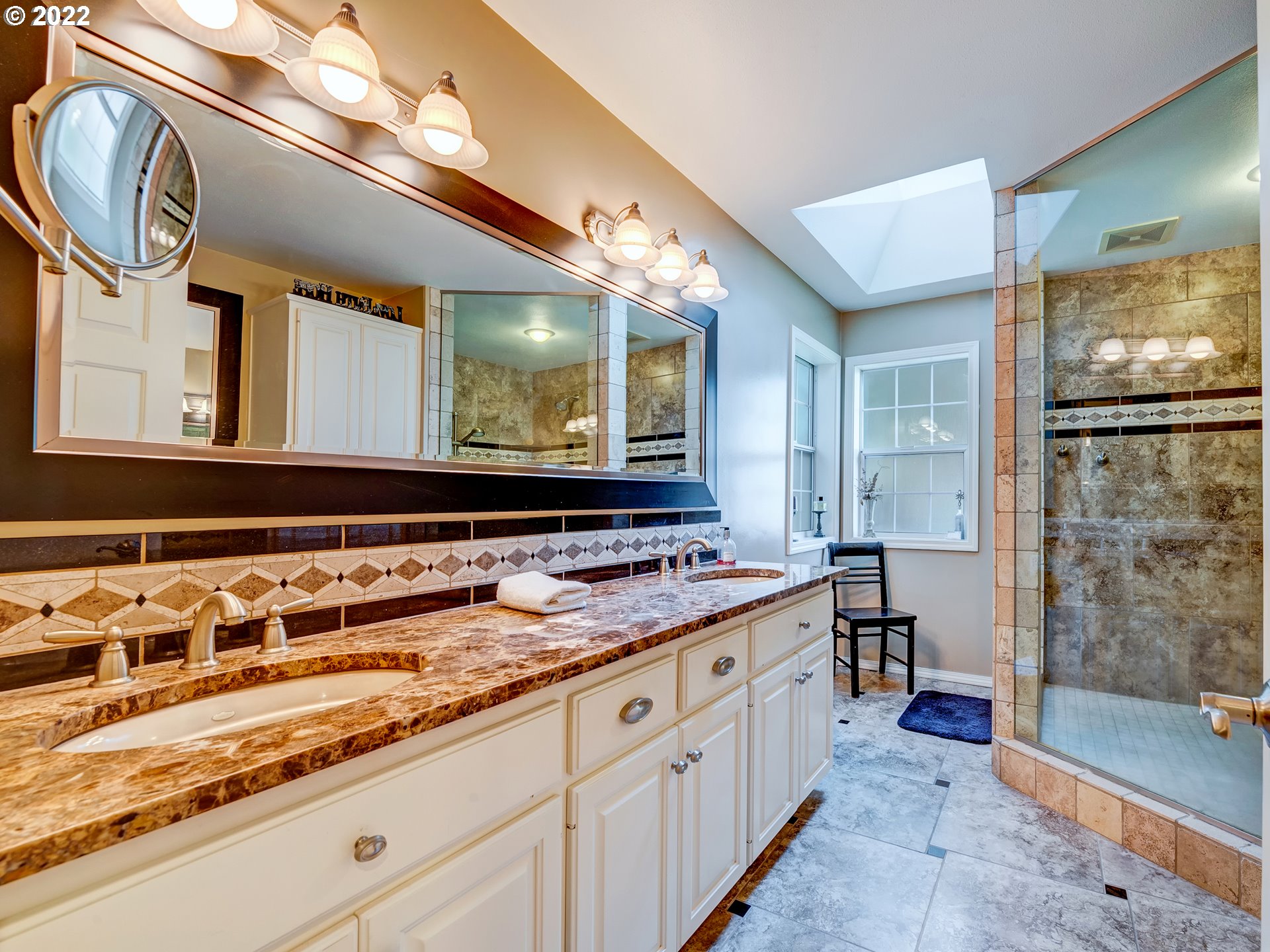 28244 Edgewater Drive Eugene, OR 97402 - Photo 10 of 30 a bathroom with a sink a large mirror and a bathtub