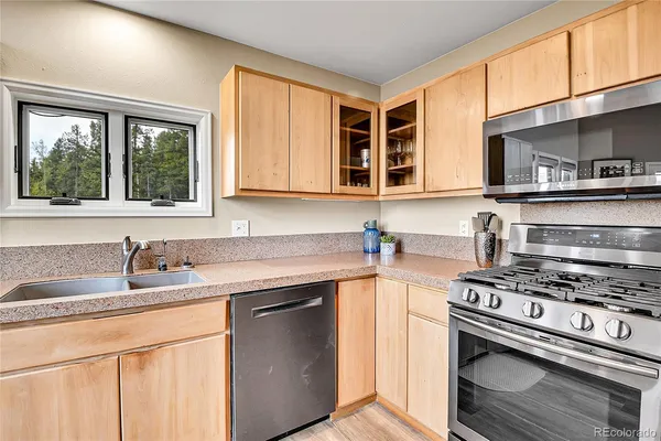 a kitchen with stainless steel appliances granite countertop a stove and a sink