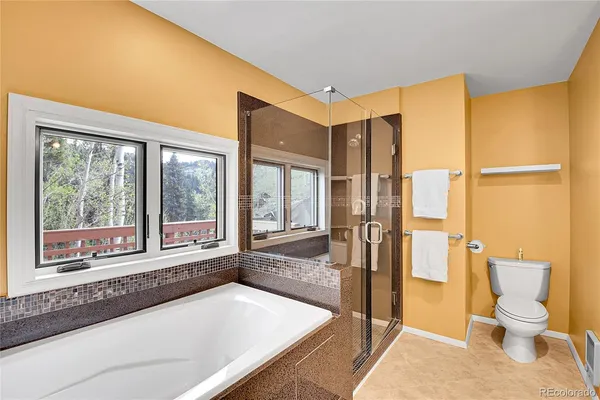a bathroom with a granite countertop sink and a large mirror