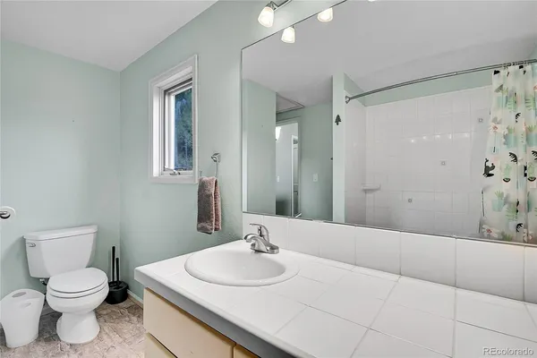 a living room with furniture a wooden floor and next to a window