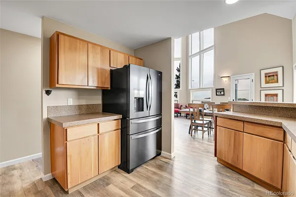 a kitchen with wooden cabinets and stainless steel appliances