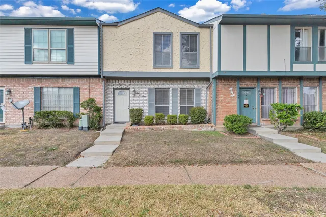 a front view of a house with a yard and a garage