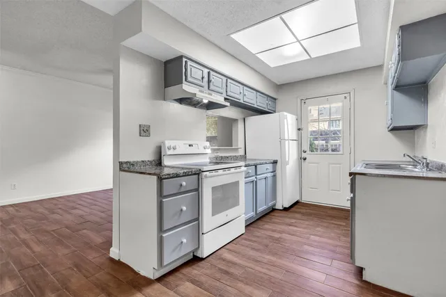 a kitchen with stainless steel appliances granite countertop a stove and a sink