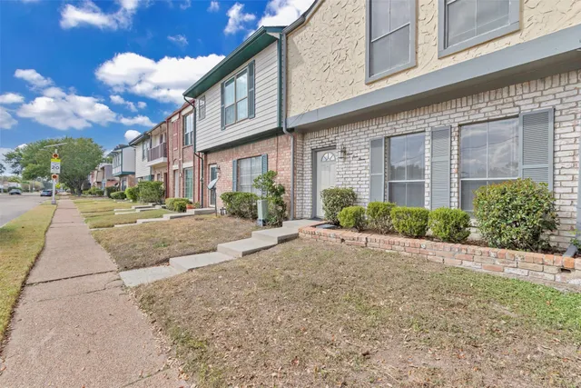 a view of a brick building next to a yard