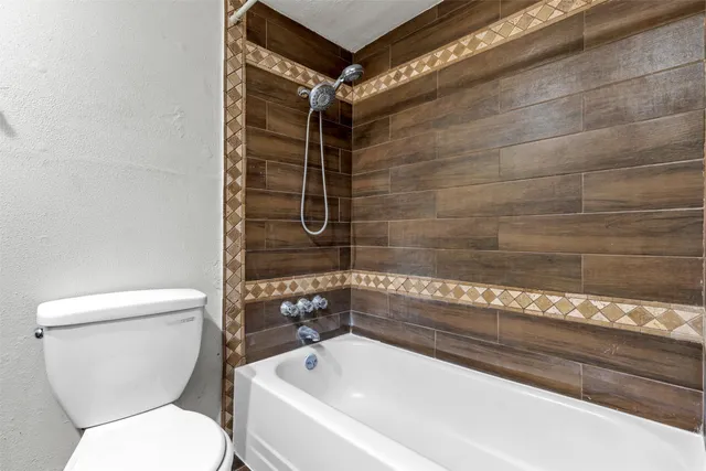 a bathroom with a toilet and shower