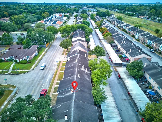 an aerial view of residential houses with outdoor space and street view