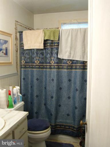 1902 Washington Road Baltimore, MD 21222 - Photo 9 of 18 a bathroom with a toilet and a shower curtain