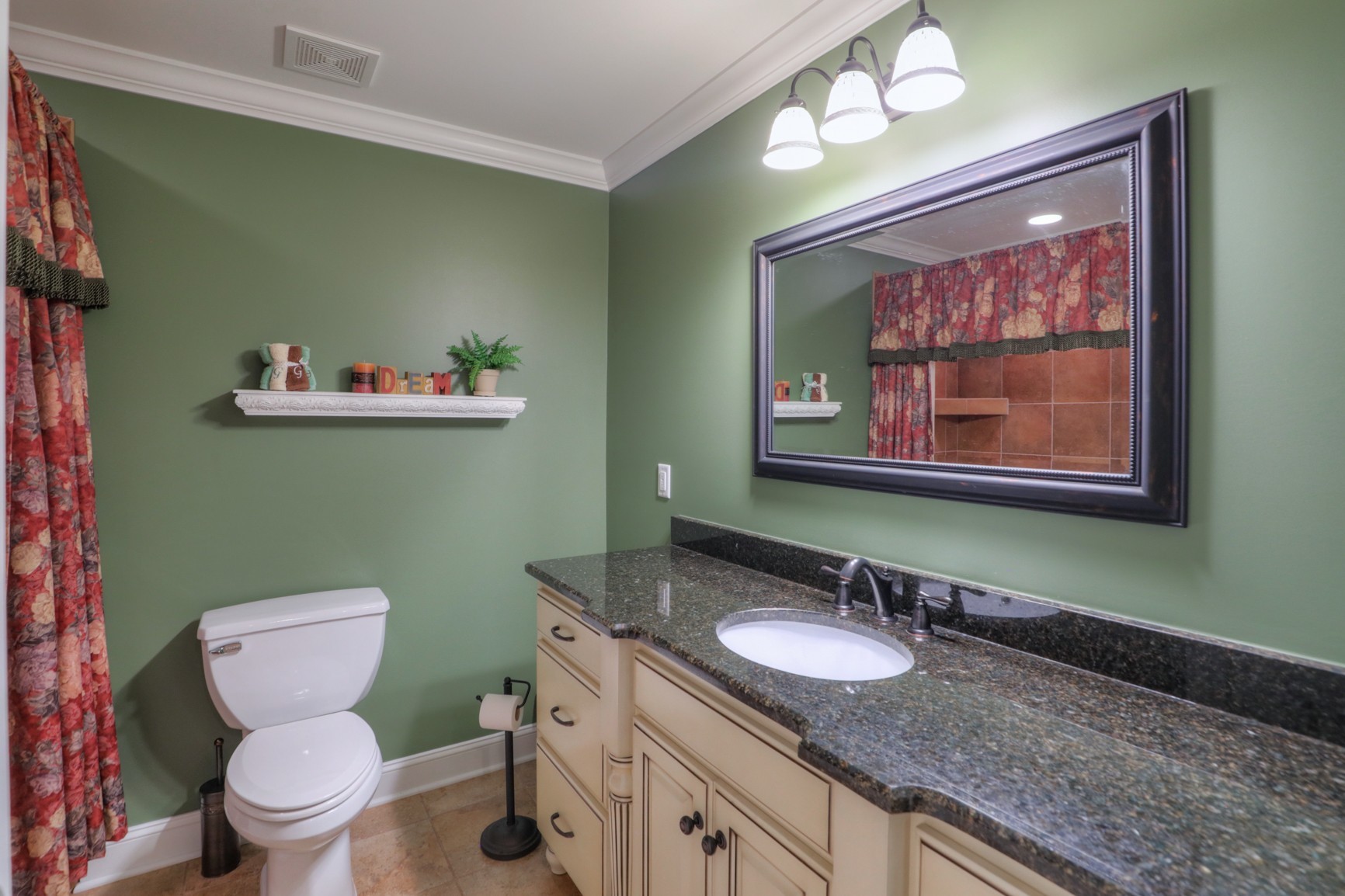 505 Bethlehem Road Lebanon, TN 37087 - Photo 38 of 44 a bathroom with a granite countertop toilet a sink and a mirror