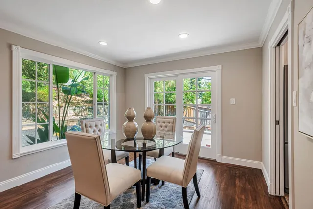 a dining room with furniture window and wooden floor