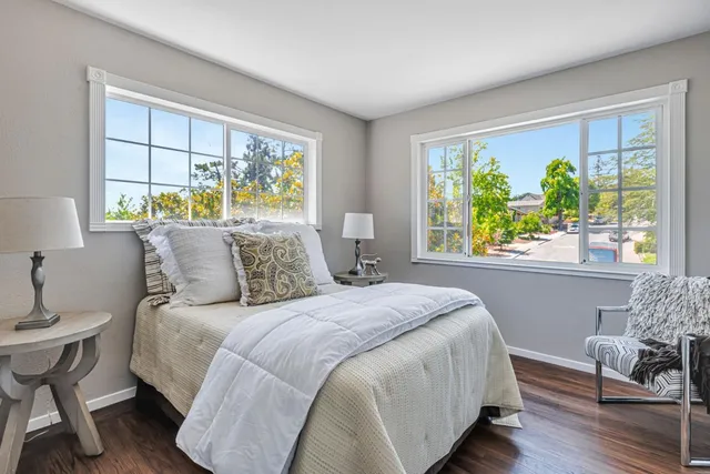 a bed sitting in a bedroom next to a window