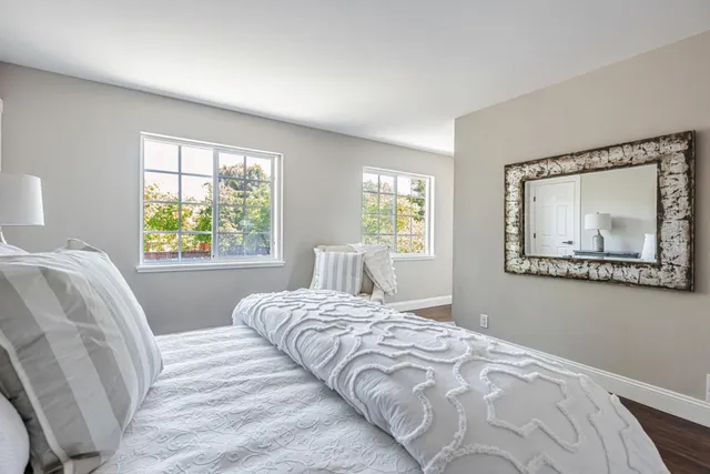 a bedroom with a bed and a painting on the wall