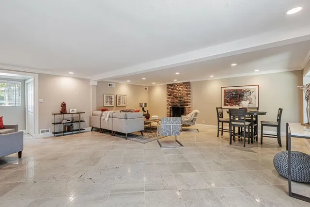 a living room with furniture and a dining table with kitchen view