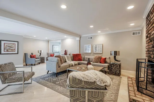 a living room with furniture a couch and a bookshelf