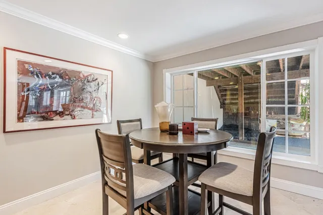 a view of a dining room with furniture and window