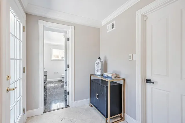 a bathroom with a toilet sink vanity and mirror