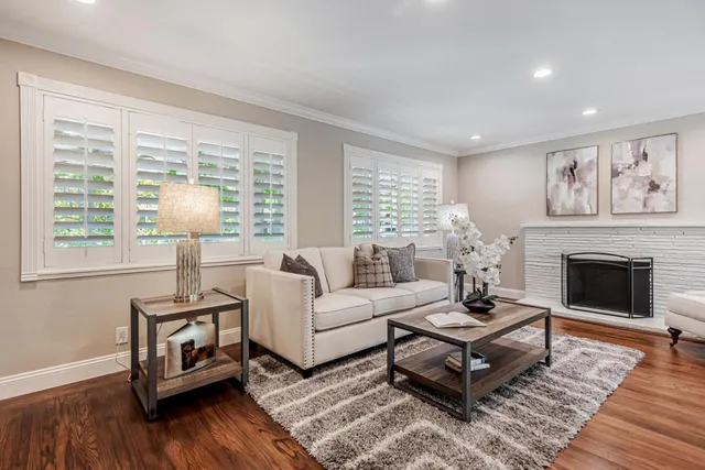 a living room with furniture and a fireplace