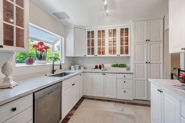 a view of cabinets a sink and a window