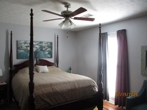 a bedroom with a bed and a mirror