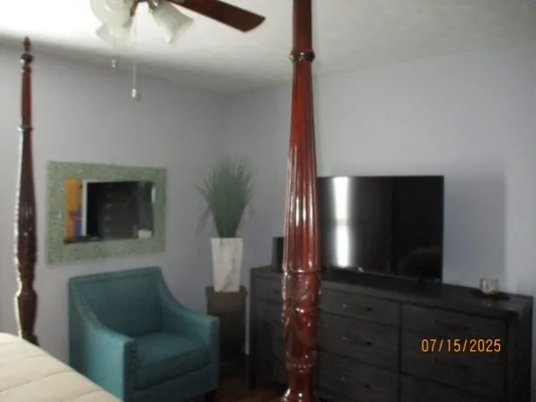 a bedroom with a bed and a window