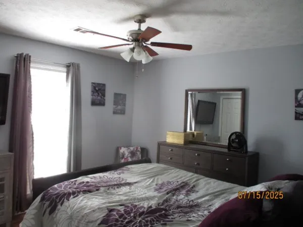 a bedroom with a bed and a dresser