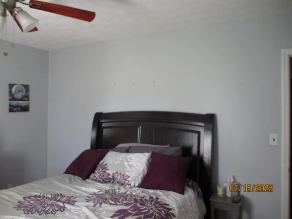a bedroom with a bed and a dresser