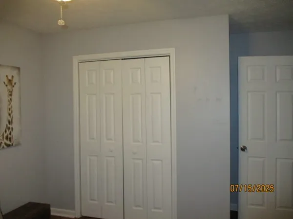 a living room with furniture a chandelier and a window