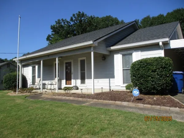 a front view of a house with a garden