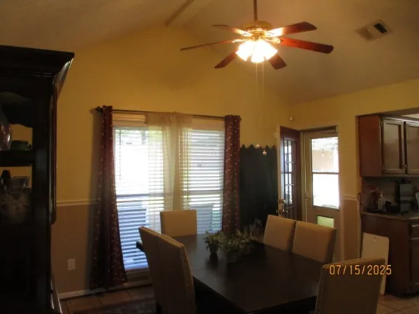 a view of a dining room with furniture and window