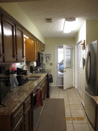 a kitchen with refrigerator and sink