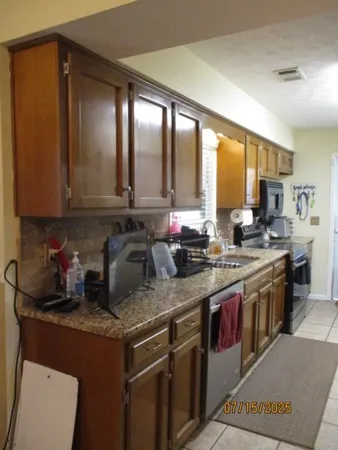 a kitchen with a refrigerator and a stove