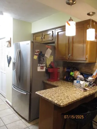 a kitchen with kitchen island a counter top space appliances and cabinets