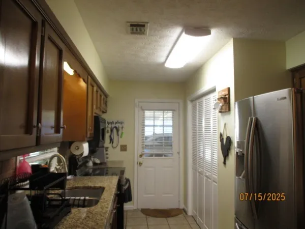 a kitchen with stainless steel appliances granite countertop a sink stove and cabinets