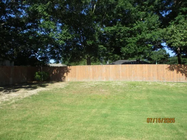 a view of house with backyard