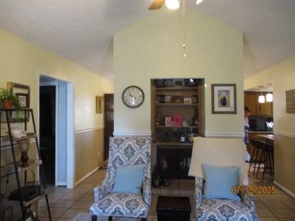 a living room with a couch and a floor to ceiling window