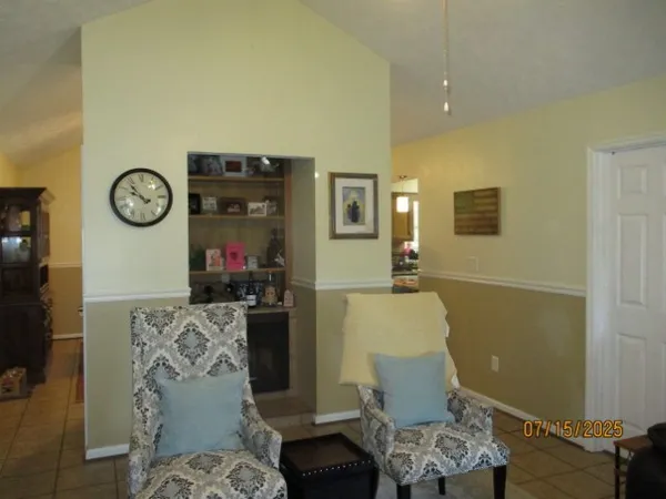 a view of a livingroom with furniture and workspace