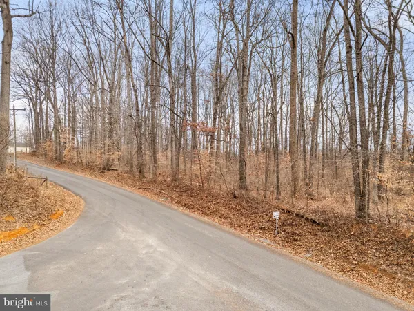 a view of backyard with wooden fence