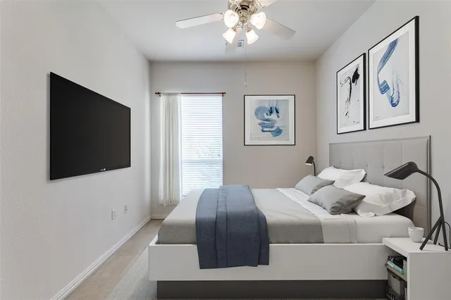 a bedroom with a large bed and a flat screen tv