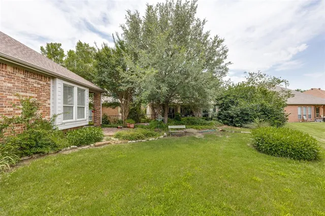 a view of a house with pool and garden