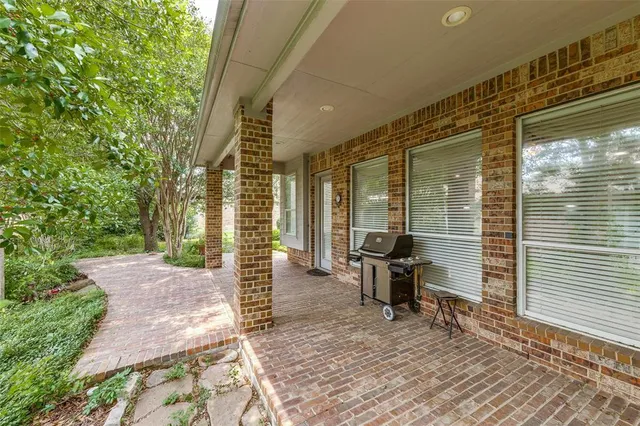 a porch with chairs and wooden floor